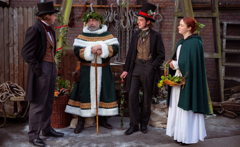 Father Christmas in green robes with Brunel and other Victorian characters